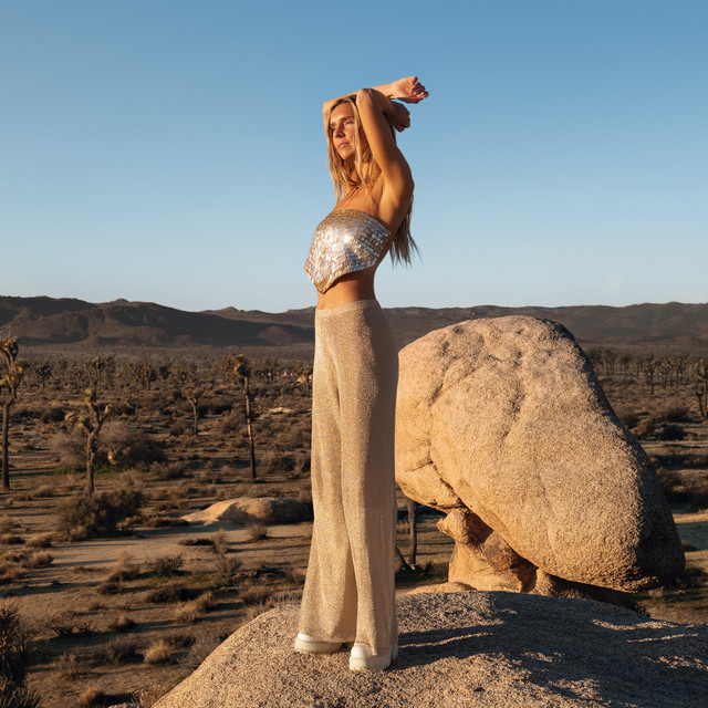 22, the album cover: mölly standing on a granite boulder in the desert
